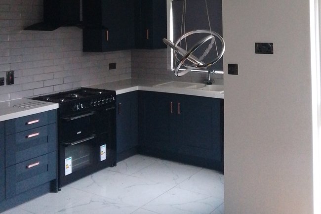 Kitchen made open plan with supporting wall knocked through