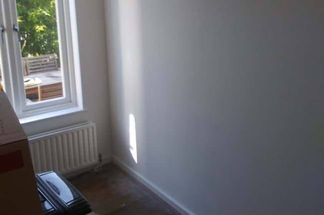 Living room painted from a blue to a fresh white.