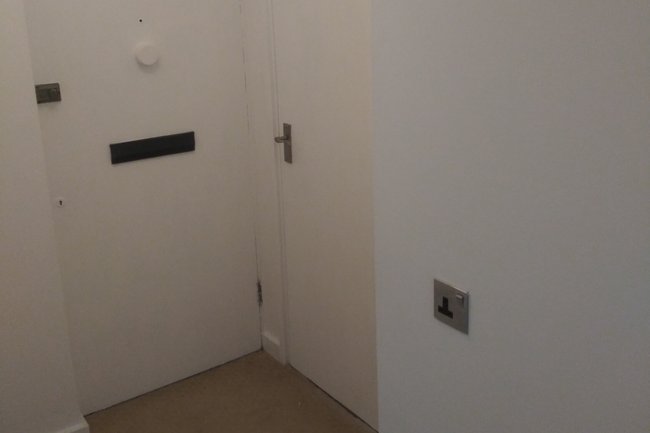 Fresh new white paint job on hallway walls and doors.