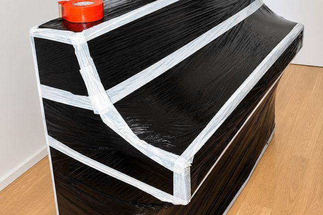 Protection d’un piano droit.