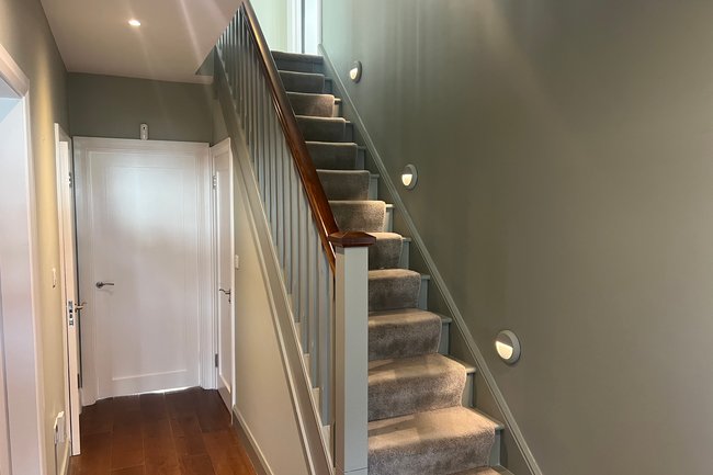 Hall stairs landing banister painted in green colours