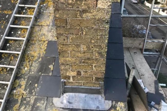 New lead chimney flashing on a man-made slate roof
