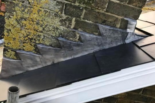 New lead chimney flashing on a man-made slate roof