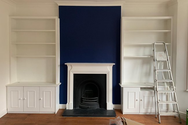 White ceiling, walls, fireplace with Royal blue feature.