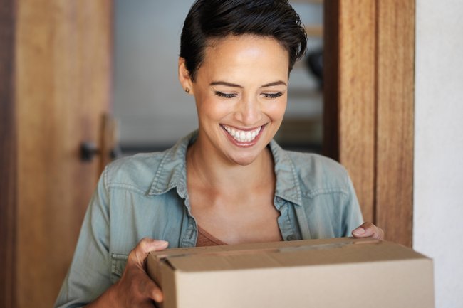 A happy customer receiving her parcel.